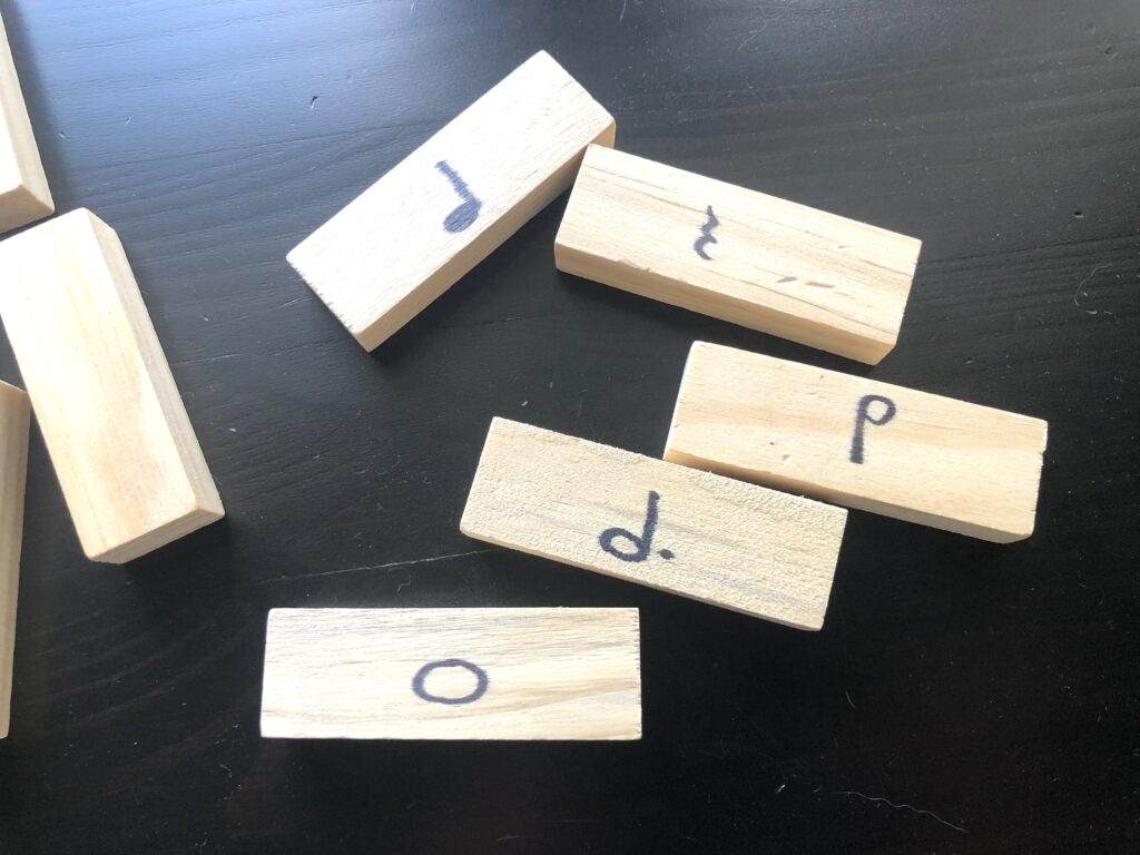Rhythm jenga game for piano lessons - image of wooden blocks with rhythms written on them
